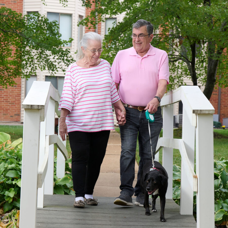 Bethesda Terrace residents walking dog across bridge