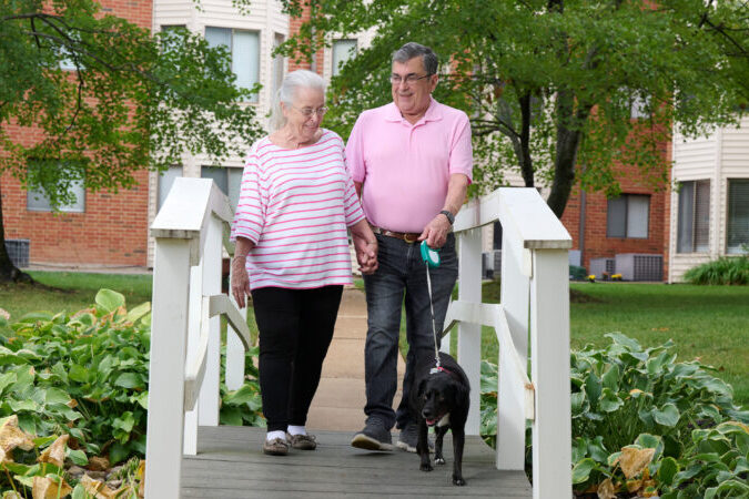 Bethesda Terrace residents walking dog across bridge