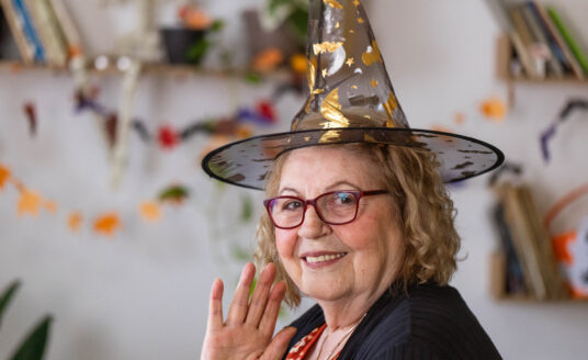 Senior woman dressed as witch, showcasing easy Halloween costumes for seniors
