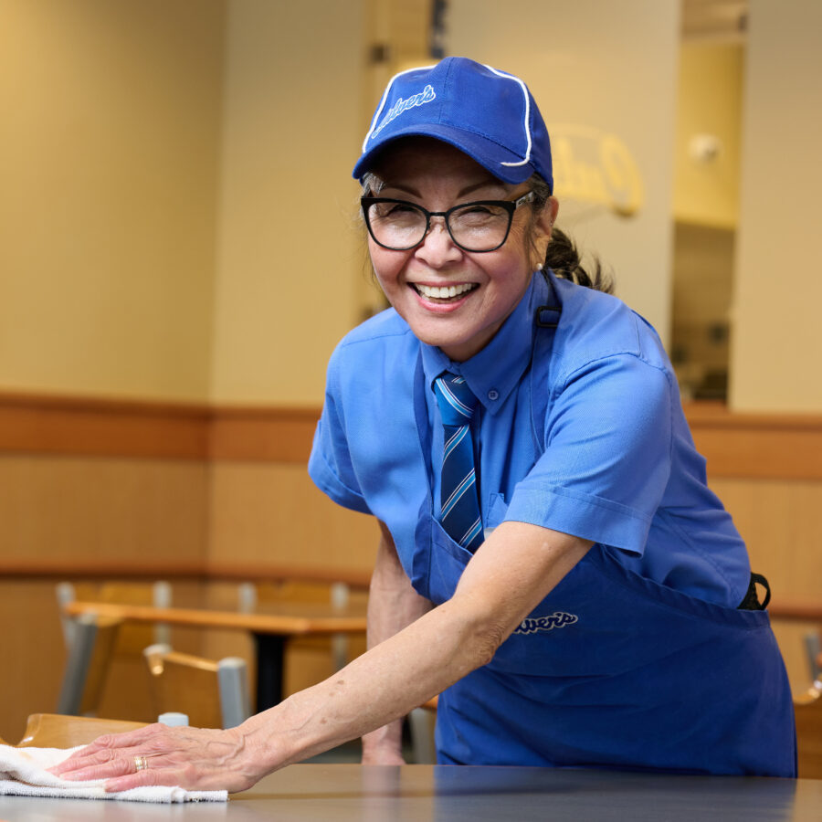 Bethesda Orchard resident, Patty, cleaning a table at her job at Culver's