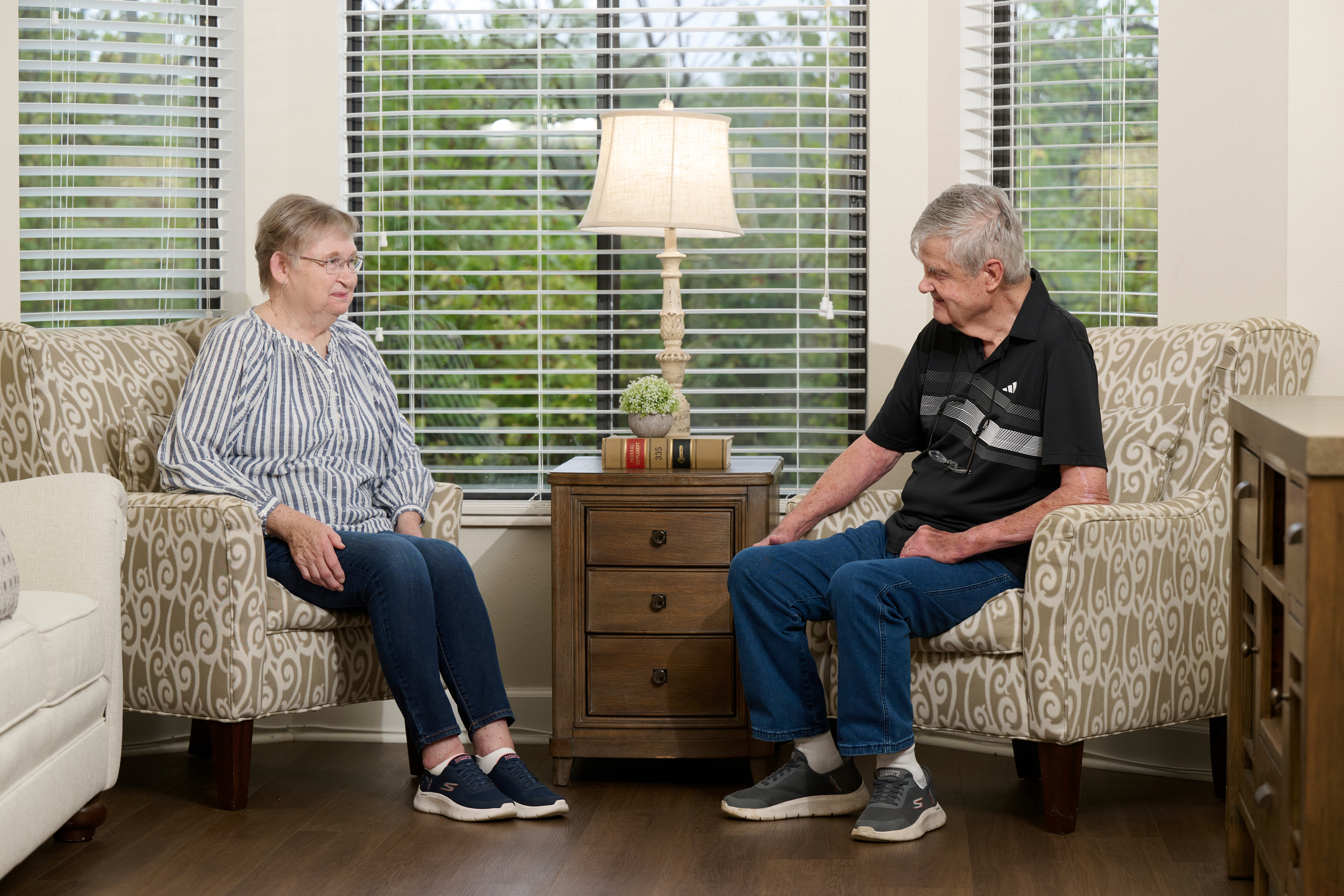 Bethesda Terrace residents sitting in front of bay window in apartment
