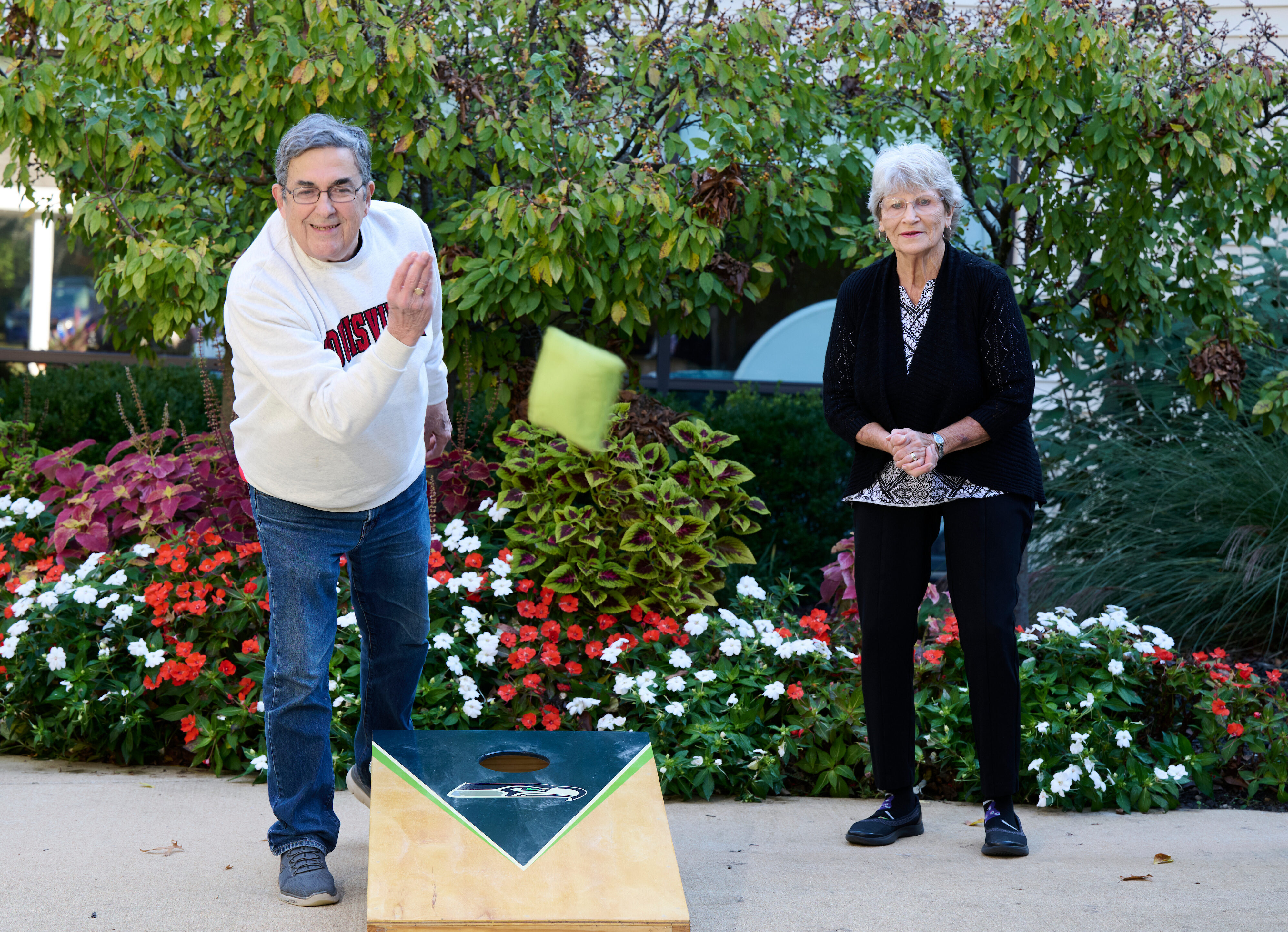 Bethesda Terrace residents playing cornhole outdoors