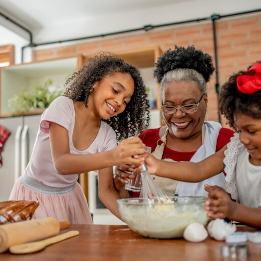Grandmother baking holiday treats with grandchildren