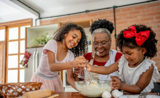 Grandmother baking holiday treats with grandchildren