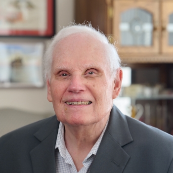 Ted smiling while sitting down