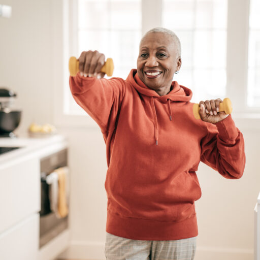 Senior woman lifting weights to work on senior fitness goals
