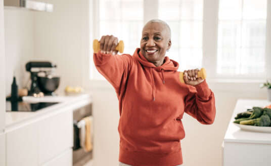 Senior woman lifting weights to work on senior fitness goals
