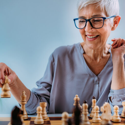 Senior woman playing chess, one of the most popular activities for seniors