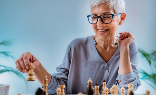 Senior woman playing chess, one of the most popular activities for seniors