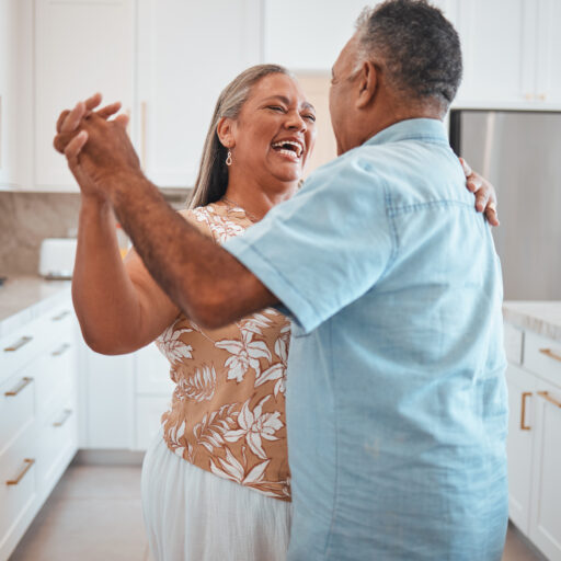 Senior couple smiling and dancing, overcoming myths about aging