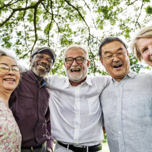 Group of senior adults smiling at camera and living active retirement lifestyle