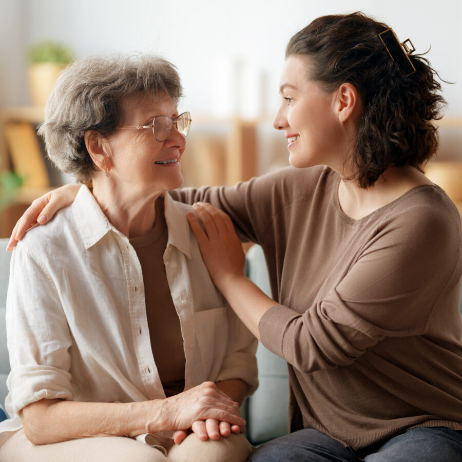 Young woman practicing the best senior care tips while caring for elderly woman