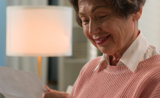 Senior woman reading written letters to seniors