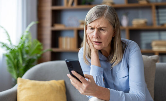 Senior woman spotting ai scams on social media for seniors